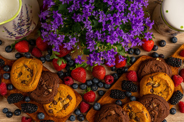 Wild fruits and chocolate biscuits with campanula close up