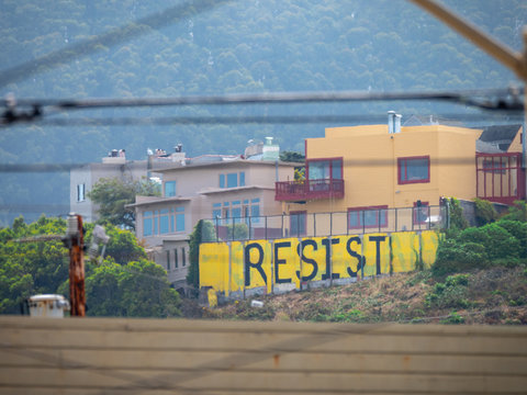 Yellow painted mural of political resistance sign of protest