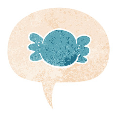 cartoon wrapped candy and speech bubble in retro textured style