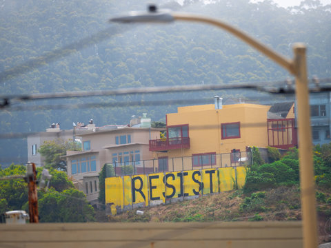 Yellow painted mural of political resistance sign of protest