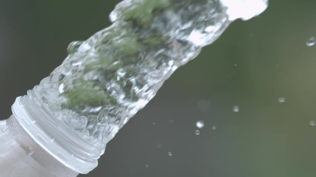 Water splashed from bottle in slow motion