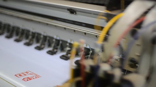 Large format inkjet printing press in operation.