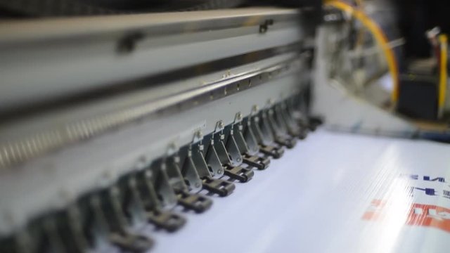 Large format inkjet printing press in operation.
