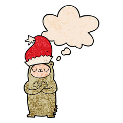 cartoon bear wearing christmas hat and thought bubble in grunge texture pattern style