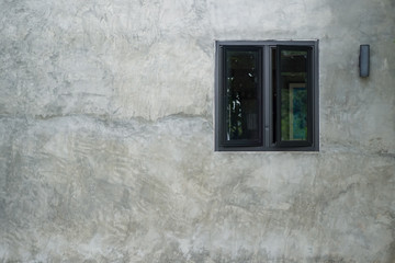 Closeup glass windows on old concrete walls. Gray concrete background.
