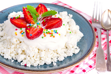 Fresh granulated cottage cheese with strawberries. Photo