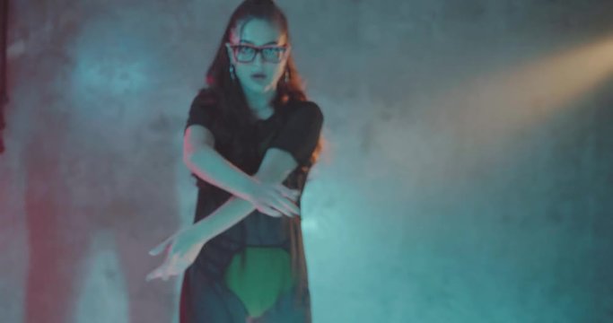 Portrait of sensual woman dancing in the studio with neon color light - video in slow motion