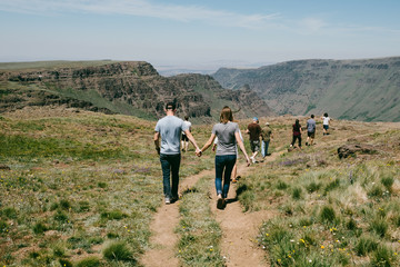 a family out on a nature walk holding hands