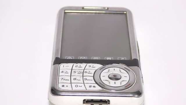 An old white mobile phone with large display moving