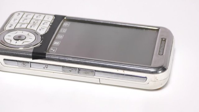 Old white mobile phone with chinese letters on display