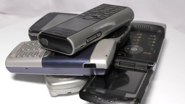 Piled up old mobile phones moving in circular motion