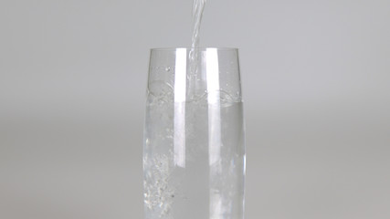 pouring water into glass