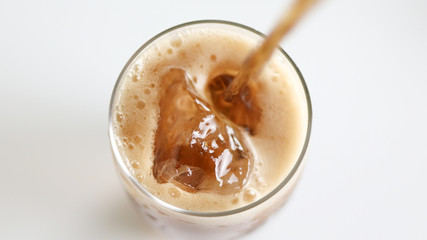 top view glass of cola with ice isolated on white background