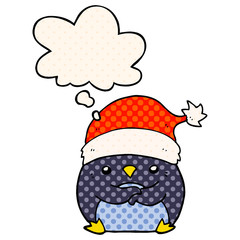 cute cartoon penguin wearing christmas hat and thought bubble in comic book style