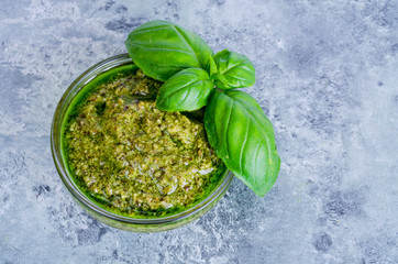 Pesto sauce and fresh green basil leaves. 