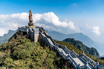 Statue of the Bodhisattva on Fansipan mountain peak the highest mountain in Indochina Backdrop Beautiful view blue sky and cloud  in Sapa, Vietnam.