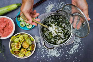 Rice basmati. Woman mix hot cooked, steamed Indian basmati rice or Chinese rice with laminaria seaweed with spoon in steel pan.
