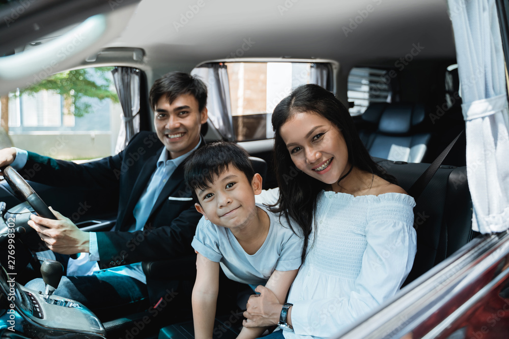 Wall mural portrait of family in formal clothes ready to go by car