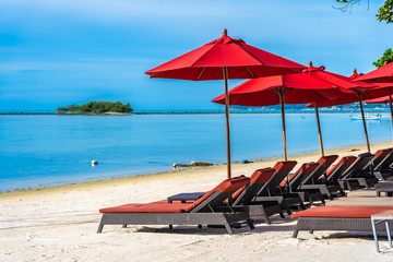 Beautiful outdoor tropical beach sea ocean with umbrella chair and lounge deck around there on white cloud blue sky