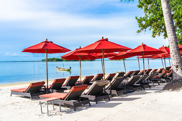 Beautiful outdoor tropical beach sea ocean with umbrella chair and lounge deck around there on white cloud blue sky