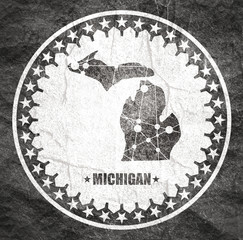 Image relative to USA travel. Michigan state map textured by lines and dots pattern. Stamp in the shape of a circle