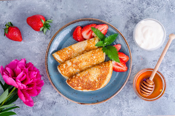 Hot sweet pancakes with fresh strawberries. Photo