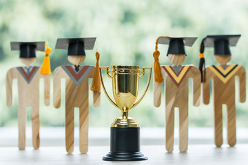 Education graduation in achievement success concept: Students university models with golden trophy...
