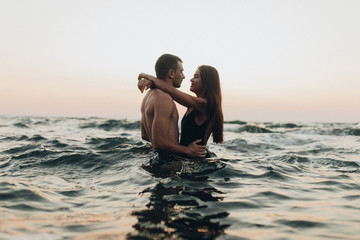 lovely couple kissing in the sea