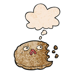 cartoon bitten cookie and thought bubble in grunge texture pattern style