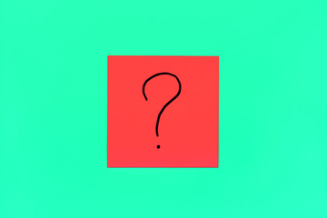 Forget, reminder, combination of colour concept- Close up black handwritten symbol of question mark on one red square sticker on mint background with copy spase, horizontal orientation