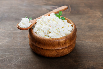 Organic cottage cheese  in a wooden bowl.