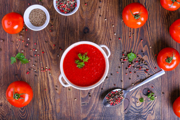 Top view of fresh tomato soup with garlic, cracked papper corns