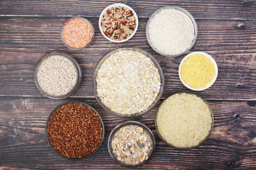 A set of bowls filled with different seeds: buckwheat, rise, corn and oatmeal