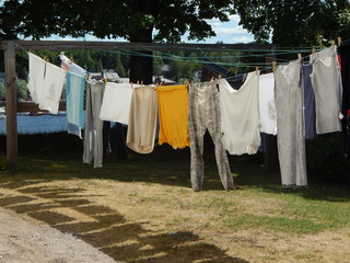 Colorful underwear is dried in the street after washing, summer in the countryside
