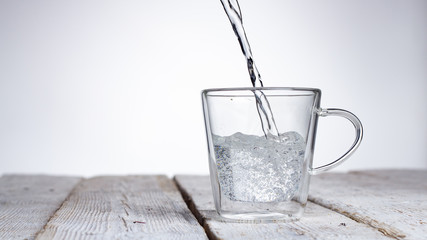spray water in a glass on a gray background