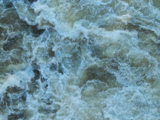 Turbulent stream of foamed water and water spray, stroma, waterfall