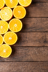 Fototapeta na wymiar Orange slices on wooden table. Top view