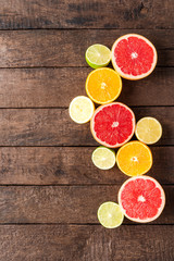 Juicy citruses on wooden background. Top view