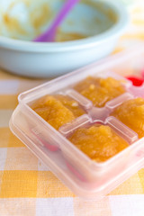 Preparing baby food, homemade. Healthy boiled or steamed crinkle sliced fresh apple preparing to be made as an ice cube in ice cube tray. Healthy food kids concept. Selective focus.Selective focus.