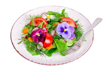 Vegetable salad with edible flowers on white background