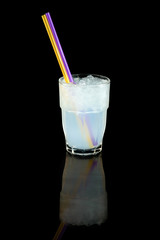 coconut water with ice cubes, concept summer cool drink with a straw, over black background