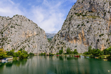 Fototapeta na wymiar Picturesque rocky banks of the Cetina river in Omis town, Dalmatia region, Croatia.