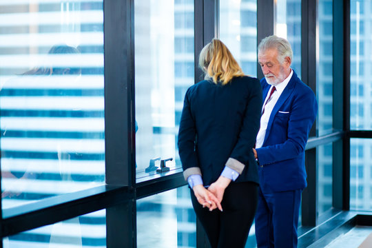 Attractive aged business man teacher or mentor coach speaking to young Business