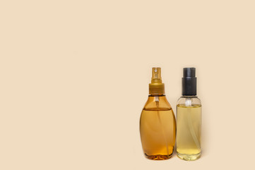 two plastic bottles with yellow massage oil