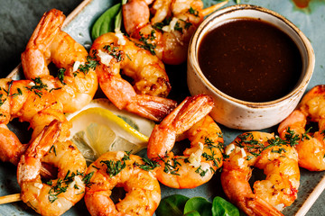 Delicious roasted shrimps on plate with lemon