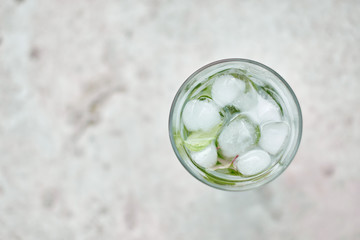 Summer hot fresh drink with mint in glass on white green grey background