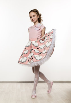 cute little girl in pink dress on white background. Children fashion, style concept.