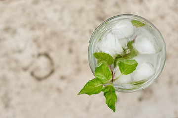 Summer hot fresh drink with mint in glass on white green grey background