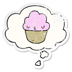 cartoon cupcake with face and thought bubble as a distressed worn sticker