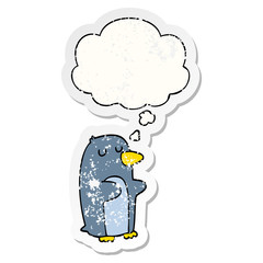 cartoon penguin and thought bubble as a distressed worn sticker